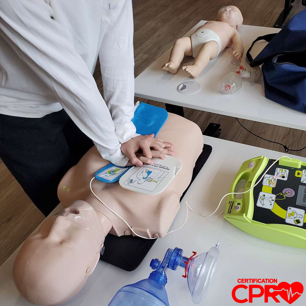 CPR training with mannequin and AED for certification in Boston.